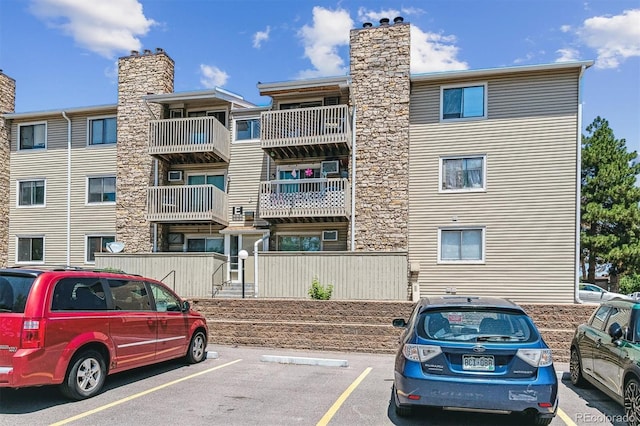 381 S Ames St Unit E104, Lakewood, CO 80226 - view of property featuring uncovered parking