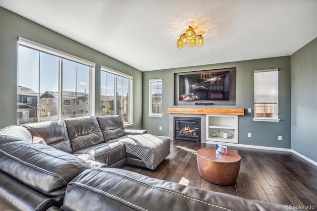 living room featuring a tile fireplace and dark hardwood / wood-style flooring