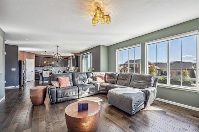 living room featuring a chandelier and dark hardwood / wood-style flooring