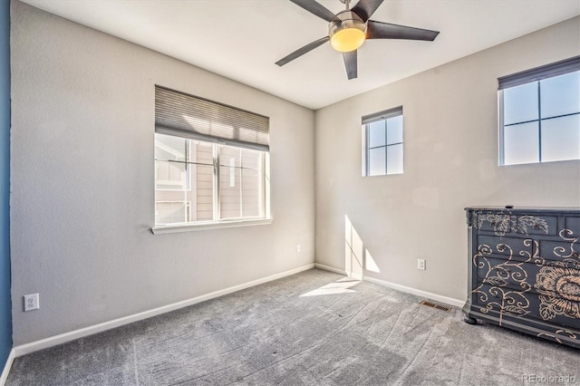 spare room with carpet and ceiling fan