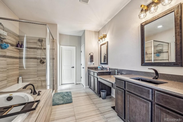 bathroom with vanity, tile patterned floors, and shower with separate bathtub