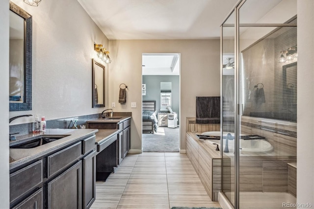 bathroom with a shower with door, tile patterned floors, and vanity