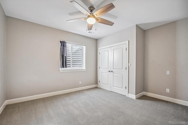 unfurnished bedroom featuring a closet, ceiling fan, and carpet flooring