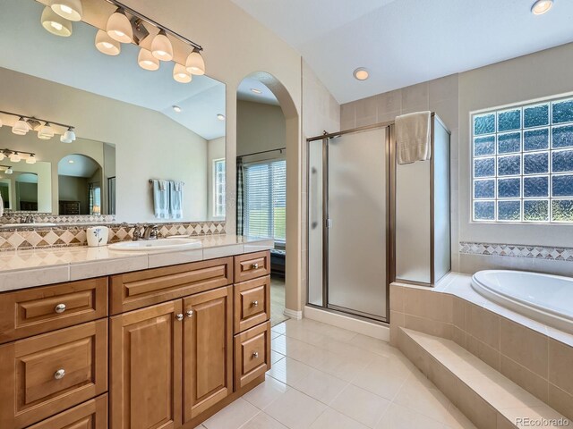 14064 E Whitaker Dr, Aurora, CO 80015 - full bath with vaulted ceiling, a shower stall, healthy amount of natural light, and vanity
