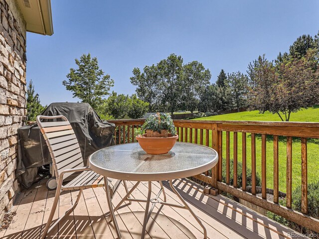 14064 E Whitaker Dr, Aurora, CO 80015 - wooden deck with a lawn and outdoor dining space