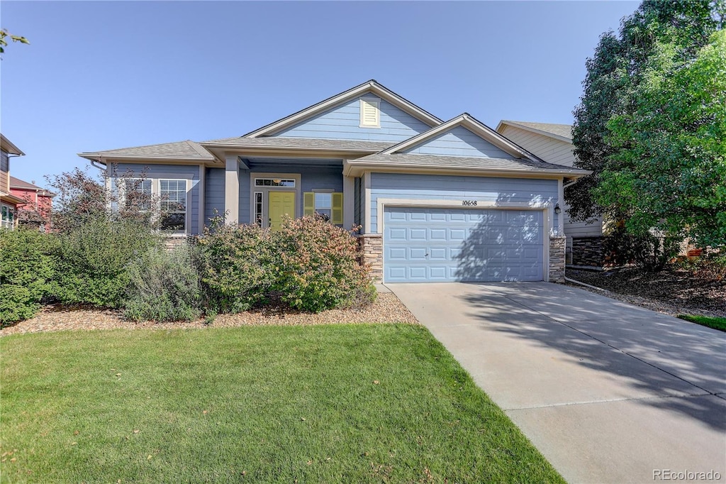 view of front of house with a garage and a front lawn