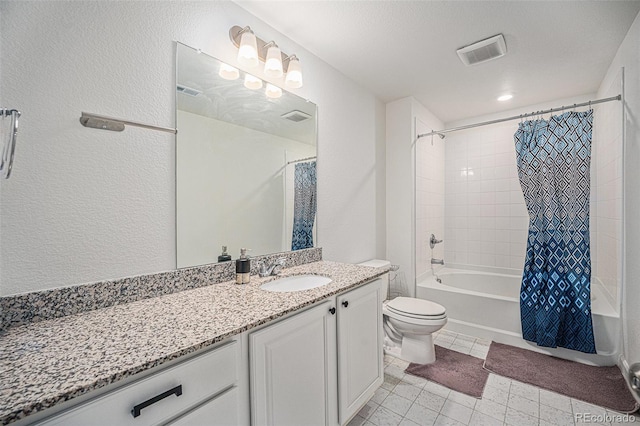 bathroom featuring a textured wall, toilet, vanity, visible vents, and shower / bath combo