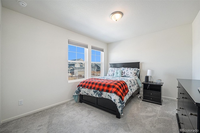 bedroom featuring carpet, a textured ceiling, and baseboards