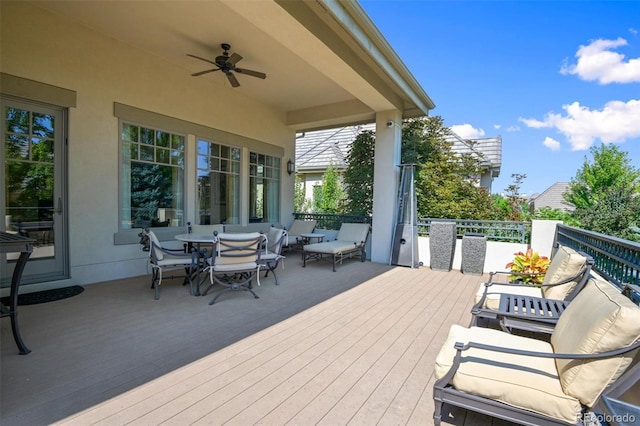 wooden terrace featuring ceiling fan