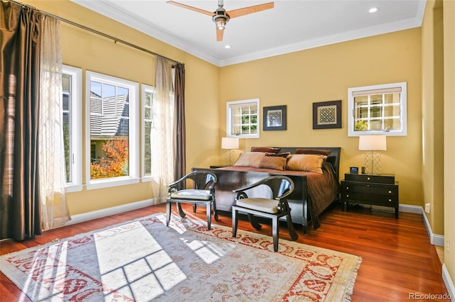 bedroom featuring ceiling fan, ornamental molding, and hardwood / wood-style floors