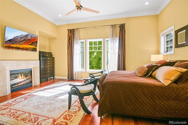 bedroom featuring crown molding, hardwood / wood-style floors, and ceiling fan