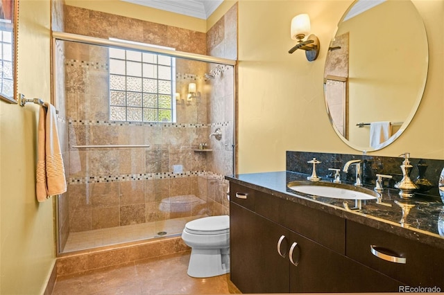 bathroom with vanity, tile patterned flooring, crown molding, toilet, and a shower with door