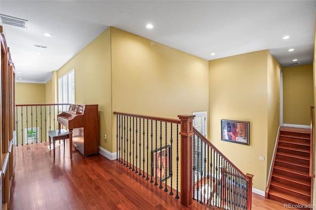 hall featuring hardwood / wood-style flooring and crown molding