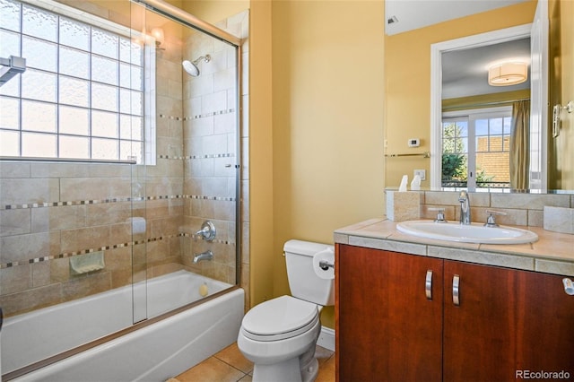 full bathroom featuring vanity, tile patterned flooring, toilet, and combined bath / shower with glass door