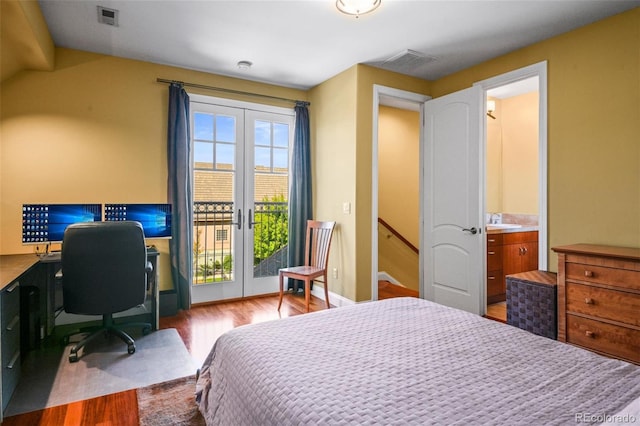 bedroom with access to outside, connected bathroom, hardwood / wood-style floors, and sink