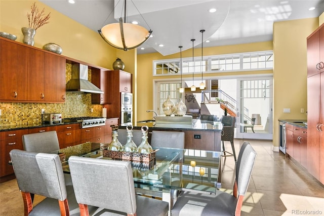 tiled dining space with a high ceiling, sink, and wine cooler