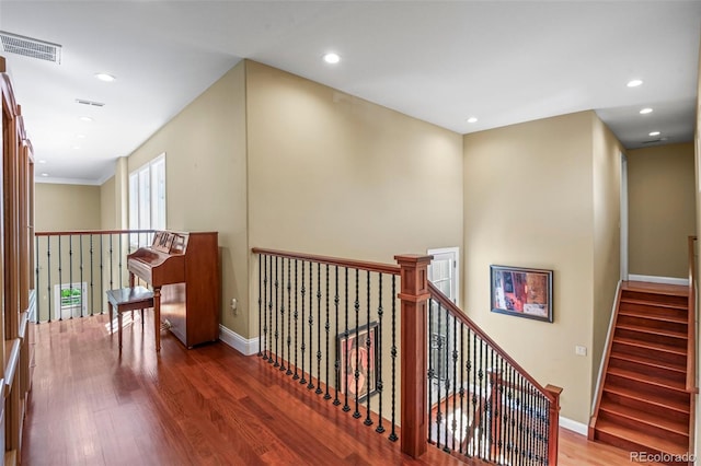 hallway featuring recessed lighting, wood finished floors, visible vents, and baseboards