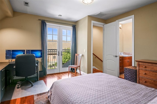 bedroom with access to exterior, visible vents, wood finished floors, and french doors