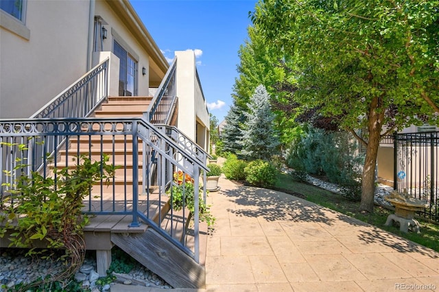 view of patio featuring stairway