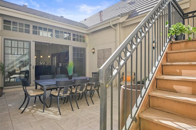 view of patio / terrace featuring stairway and outdoor dining area