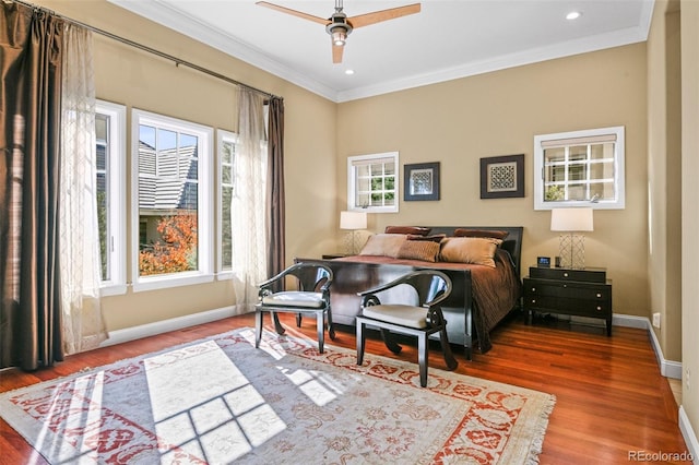 bedroom with ornamental molding, recessed lighting, baseboards, and wood finished floors