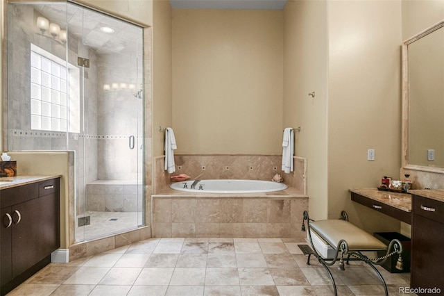 bathroom with a stall shower, a garden tub, vanity, and tile patterned floors