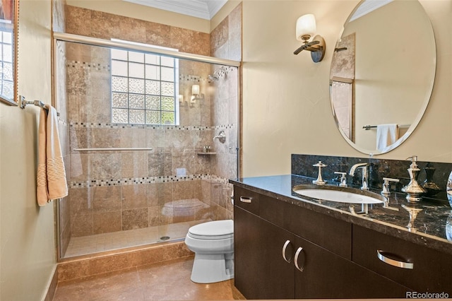 full bathroom featuring toilet, a shower stall, ornamental molding, and vanity