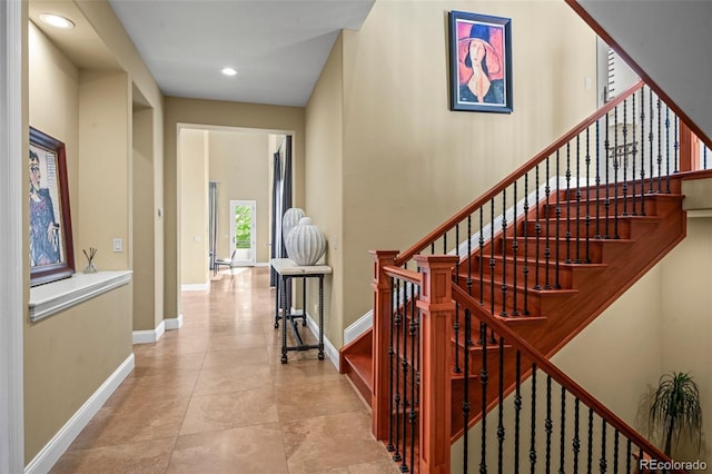 stairway with recessed lighting, baseboards, and tile patterned floors