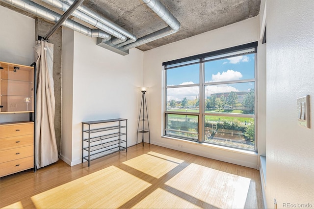 empty room with baseboards and wood finished floors