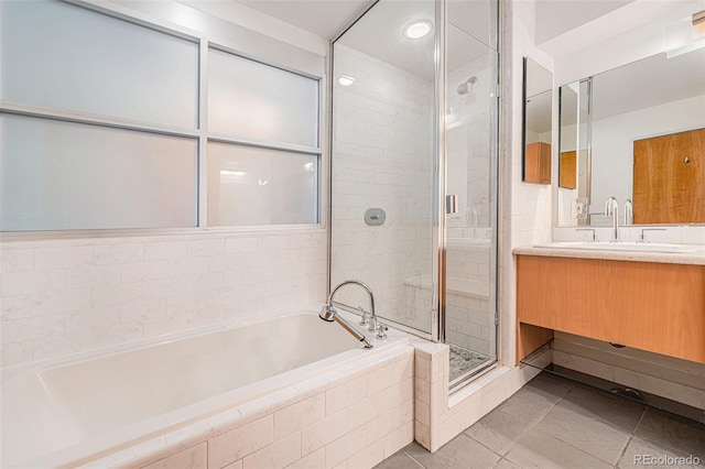 bathroom featuring tile patterned flooring, separate shower and tub, and vanity