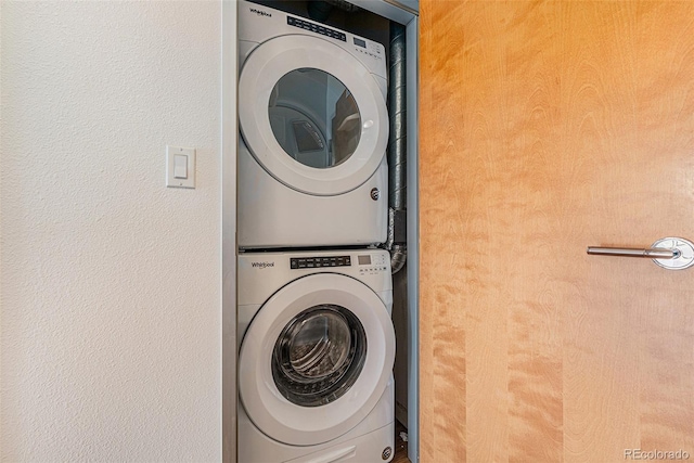 laundry area with stacked washer and dryer