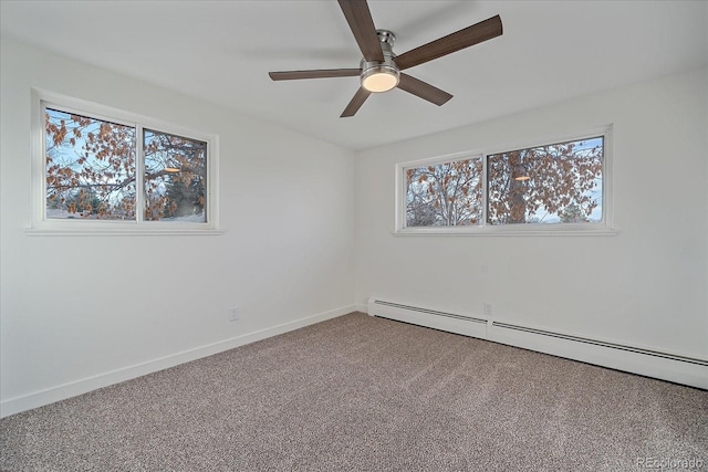 carpeted spare room with baseboard heating and ceiling fan