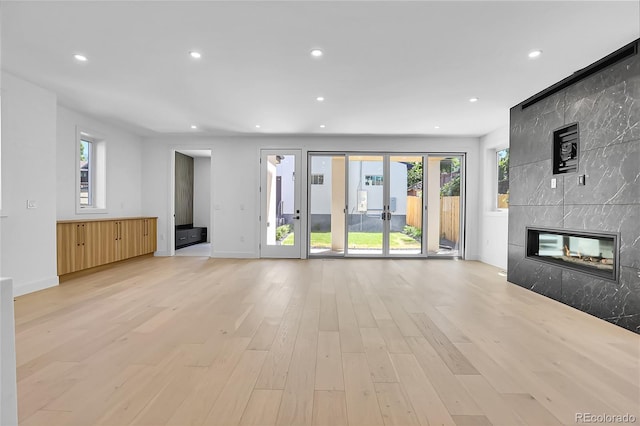 300 S Franklin St, Denver, CO 80209 - unfurnished living room featuring light wood-type flooring, recessed lighting, a high end fireplace, and plenty of natural light