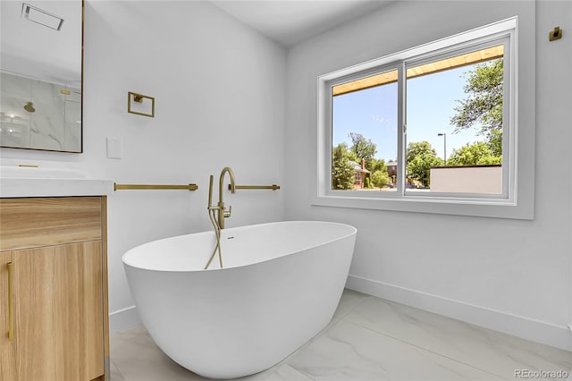 300 S Franklin St, Denver, CO 80209 - bathroom featuring healthy amount of natural light, vanity, and a freestanding bath