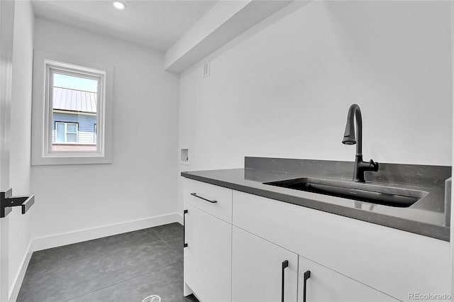 300 S Franklin St, Denver, CO 80209 - washroom with washer hookup, cabinet space, recessed lighting, and dark tile patterned floors