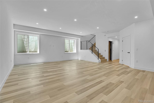 300 S Franklin St, Denver, CO 80209 - unfurnished living room featuring stairs, light wood-type flooring, and recessed lighting