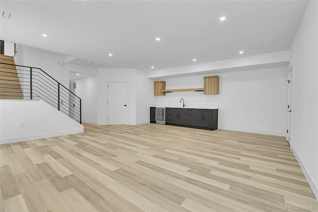 300 S Franklin St, Denver, CO 80209 - unfurnished living room featuring recessed lighting, stairs, bar with sink, wine cooler, and light wood-style flooring