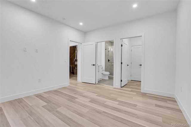 300 S Franklin St, Denver, CO 80209 - unfurnished bedroom with a walk in closet, light wood-style floors, recessed lighting, and ensuite bathroom