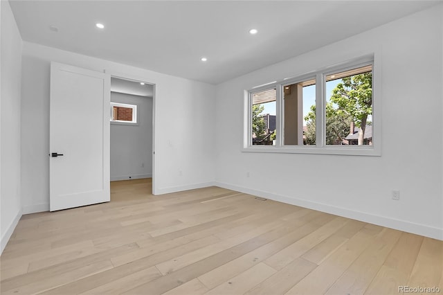 300 S Franklin St, Denver, CO 80209 - unfurnished bedroom featuring light wood-type flooring, multiple windows, recessed lighting, and a walk in closet