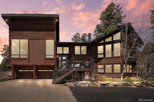 8453 S Scenic Dr, Morrison, CO 80465 - contemporary house with an attached garage, concrete driveway, and stairway