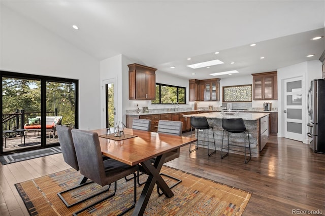 8453 S Scenic Dr, Morrison, CO 80465 - dining room with dark wood-type flooring, recessed lighting, high vaulted ceiling, and a skylight