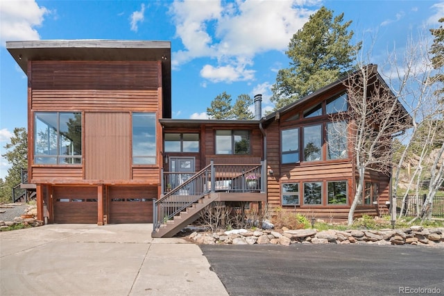 8453 S Scenic Dr, Morrison, CO 80465 - view of front of property with a garage, concrete driveway, and stairway
