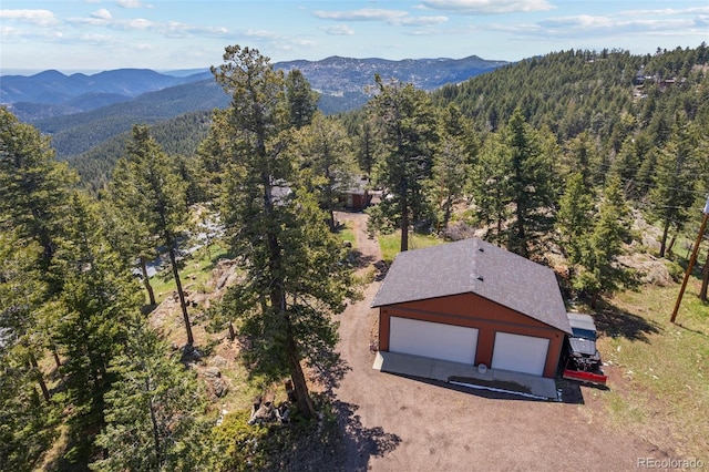 8453 S Scenic Dr, Morrison, CO 80465 - aerial view of property and surrounding area with a heavily wooded area and a mountain backdrop
