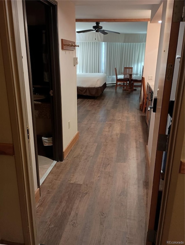 hallway with hardwood / wood-style flooring