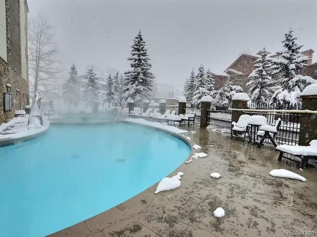 view of snow covered pool