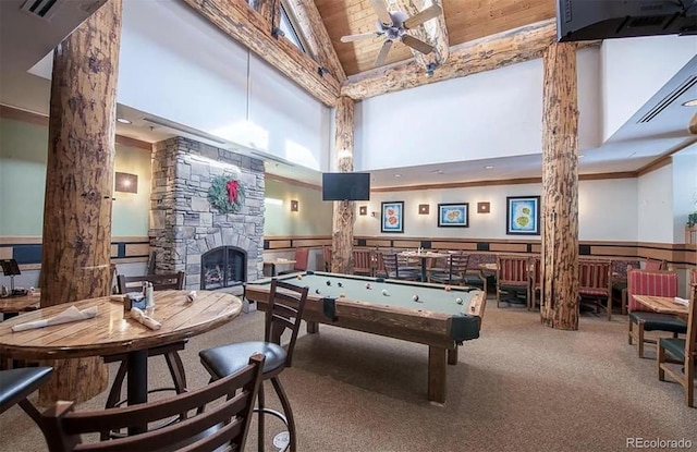 game room with carpet, ceiling fan, wooden ceiling, a fireplace, and high vaulted ceiling