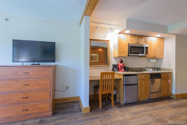 6 Emmons Rd Unit 515, Mount Crested Butte, CO 81225 - kitchen featuring appliances with stainless steel finishes, wood finished floors, track lighting, light countertops, and recessed lighting