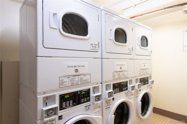 6 Emmons Rd Unit 515, Mount Crested Butte, CO 81225 - communal laundry room featuring stacked washer / drying machine, washer and dryer, and tile patterned flooring
