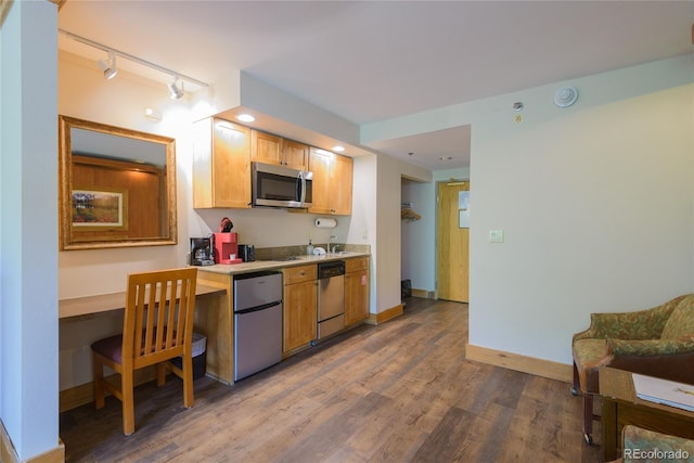6 Emmons Rd Unit 515, Mount Crested Butte, CO 81225 - kitchen featuring stainless steel appliances, rail lighting, wood finished floors, and light countertops