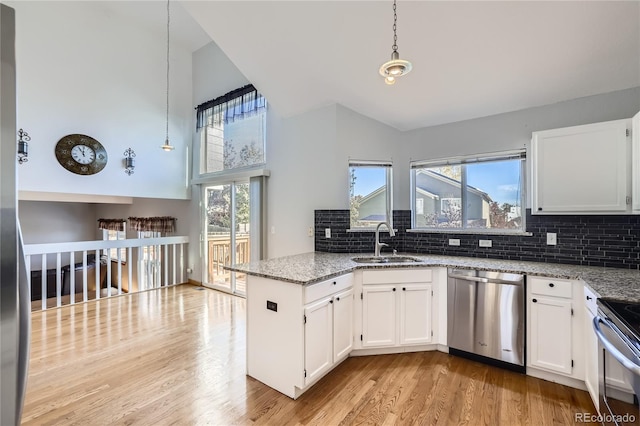 kitchen featuring white cabinetry, pendant lighting, sink, and stainless steel appliances